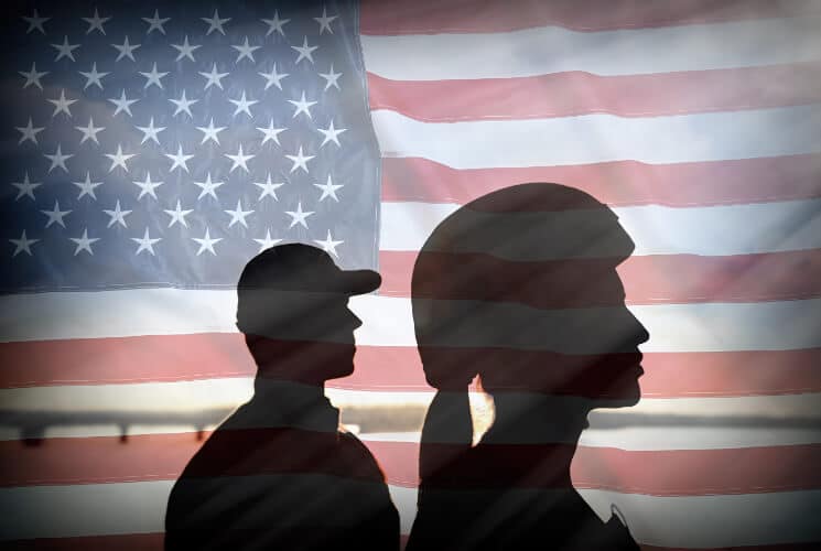 a man and woman soldier silhouette in from of an American Flag