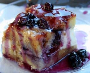 Bread casserole with blueberries and cream cheese and maple syrup