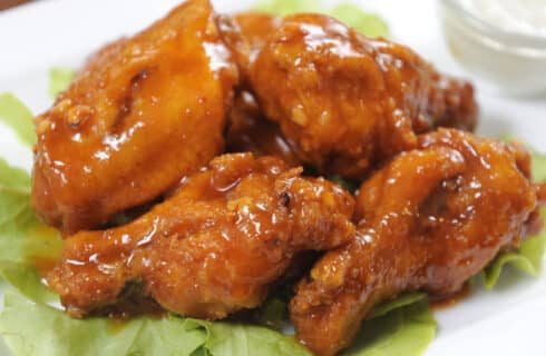 Buffalo Chicken Wings on a bed of lettuce with blue cheese dressing