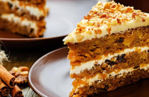Layeres of Carrot Cake with Cream Cheese Frosting, sprinkled with Chopped Nuts