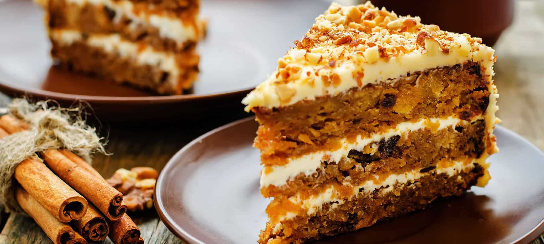 Layeres of Carrot Cake with Cream Cheese Frosting, sprinkled with Chopped Nuts