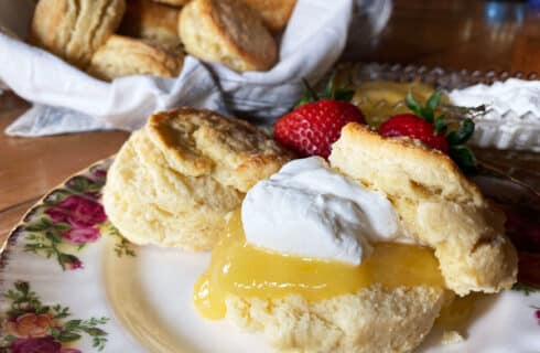 Flaky golden scones with lemon curdc devonshire cream, and fresh strawberries