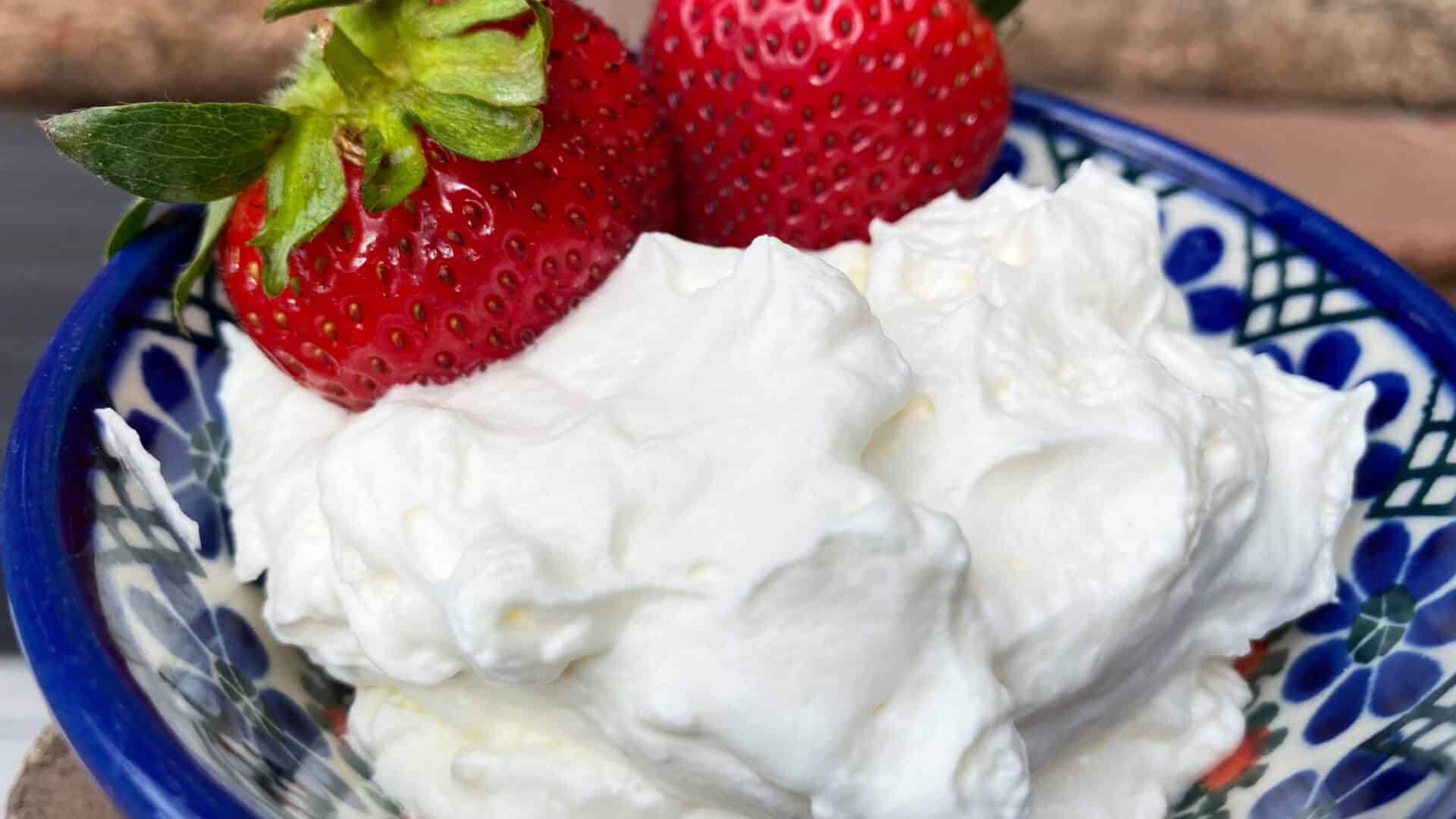 Light and Fluffy Cream with fresh red strawberries with green leaves