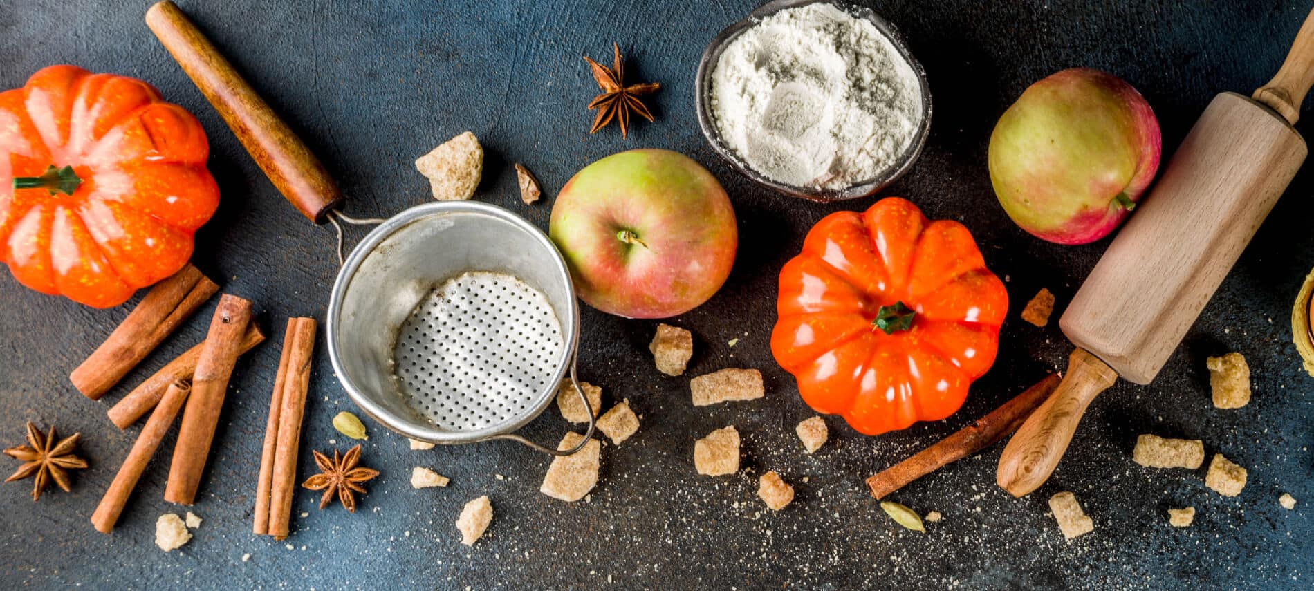 Fall Baking ingredients of apples, pumpkins, flour, and spices