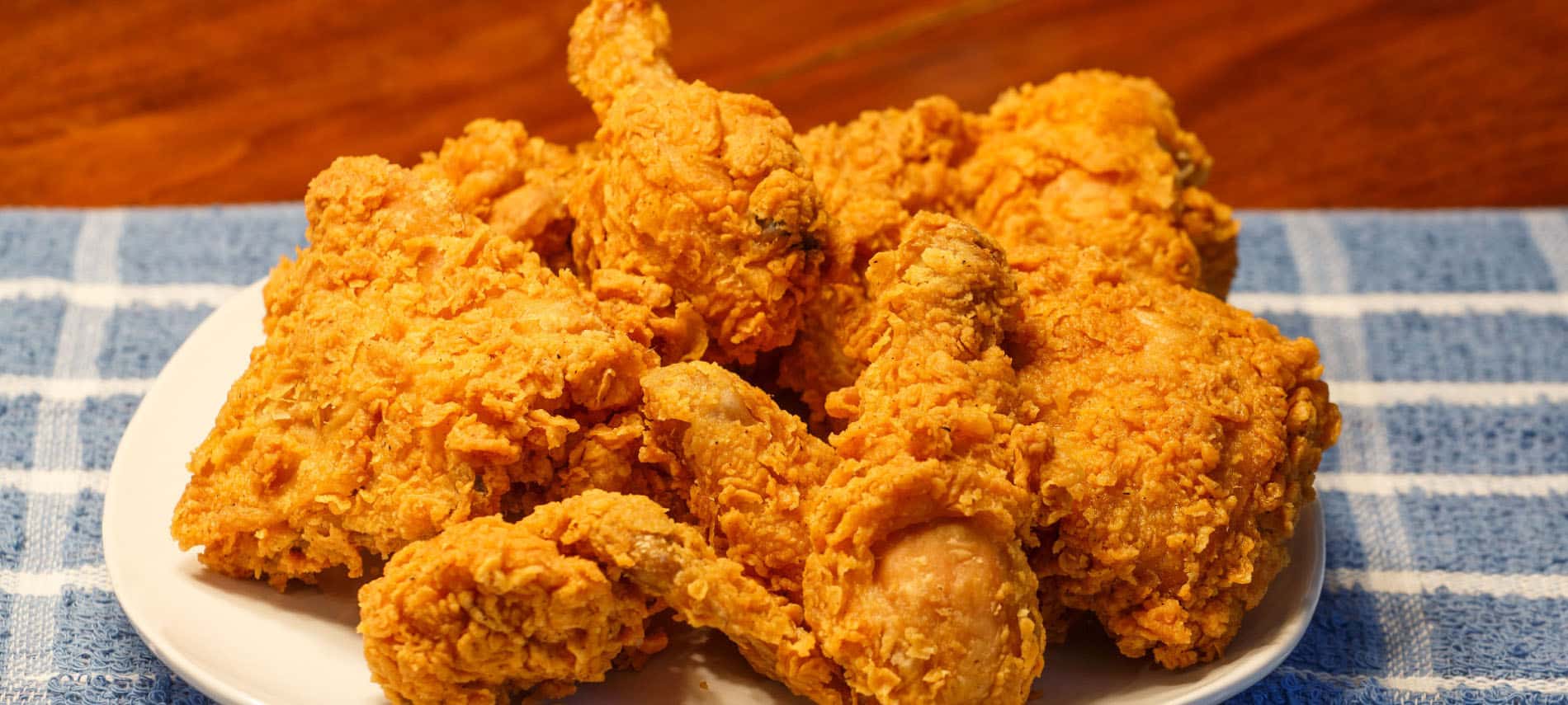 Fried chicken on a white plate and blue towel