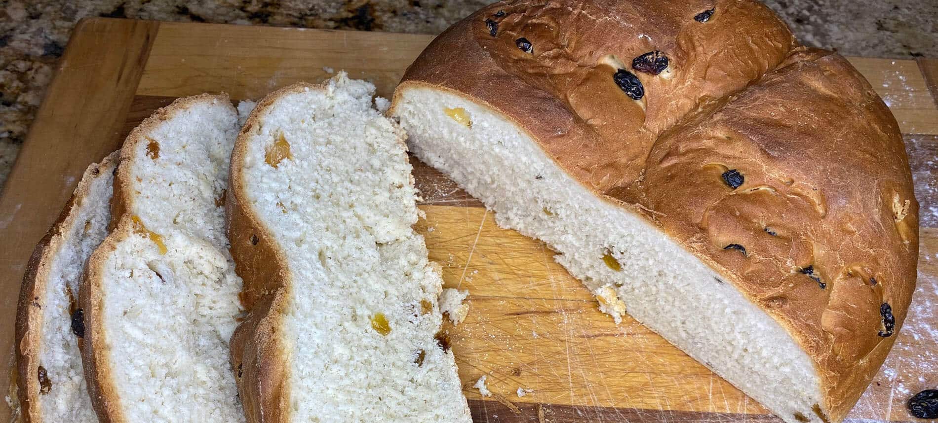 Irish Soda Bread with Golden Raisins on a wooden cutting board