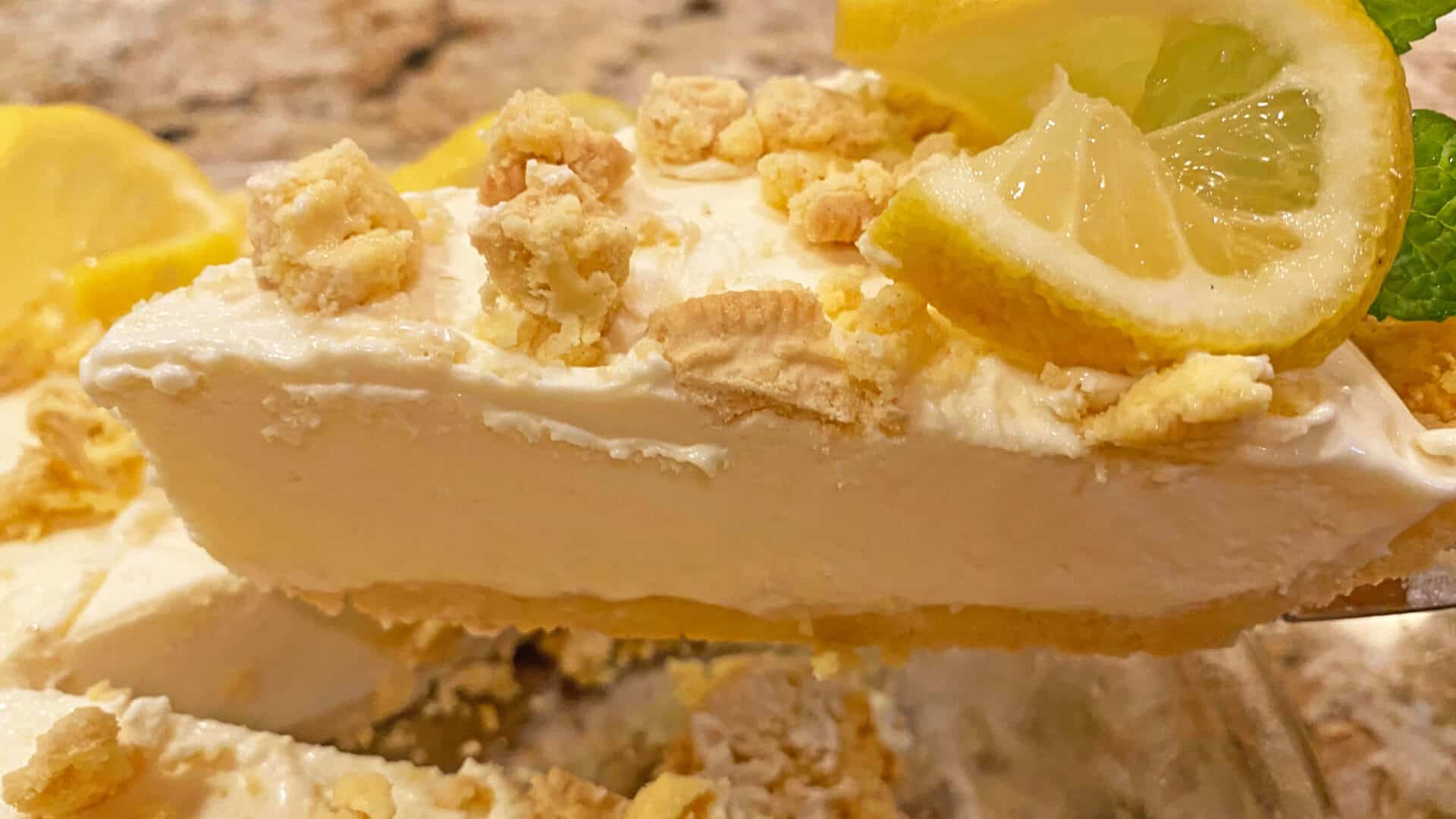 Creamy Lemon Pie with cookie crumb curst and toppings with a lemon twist