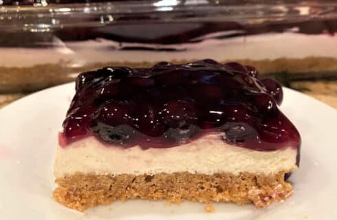 Blueberry Cheesecake with a graham cracker crust, cream cheese filling, and blueberry topping