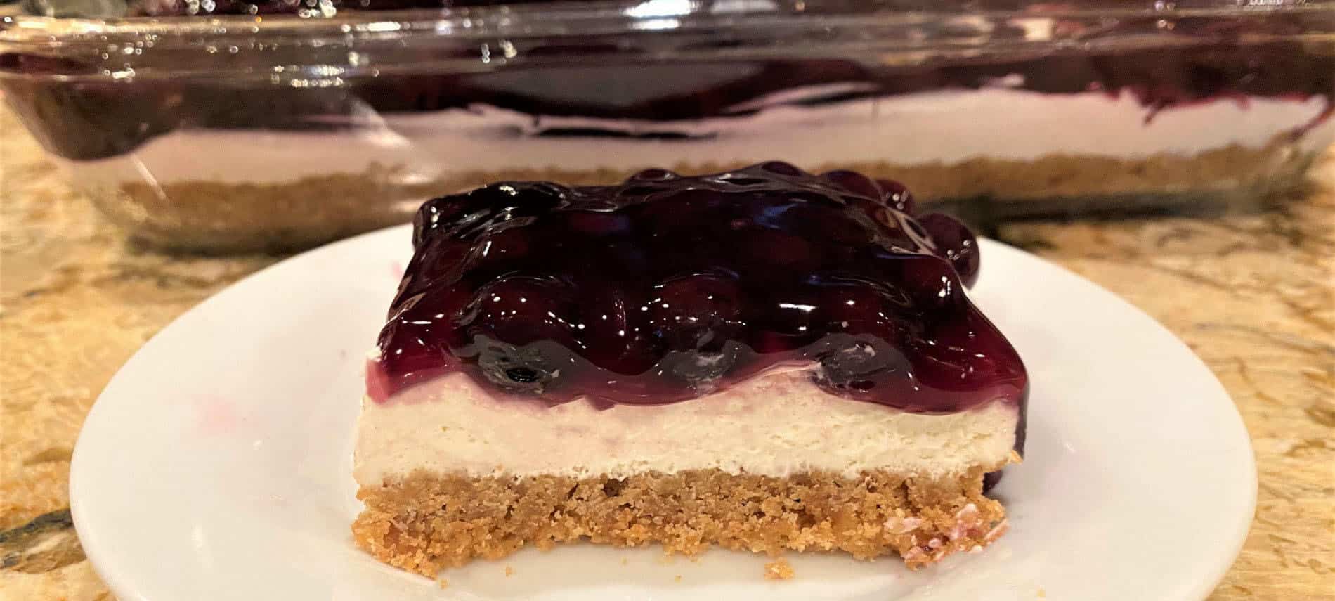 Blueberry Cheesecake with a graham cracker crust, cream cheese filling, and blueberry topping