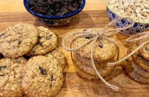 Oatmeal Raisin Cookies with bowls of oats and raisins