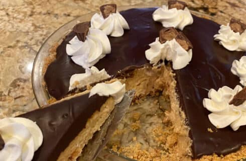Peanut Butter Pie with dollops of whip;ped cream and peanut butter cups