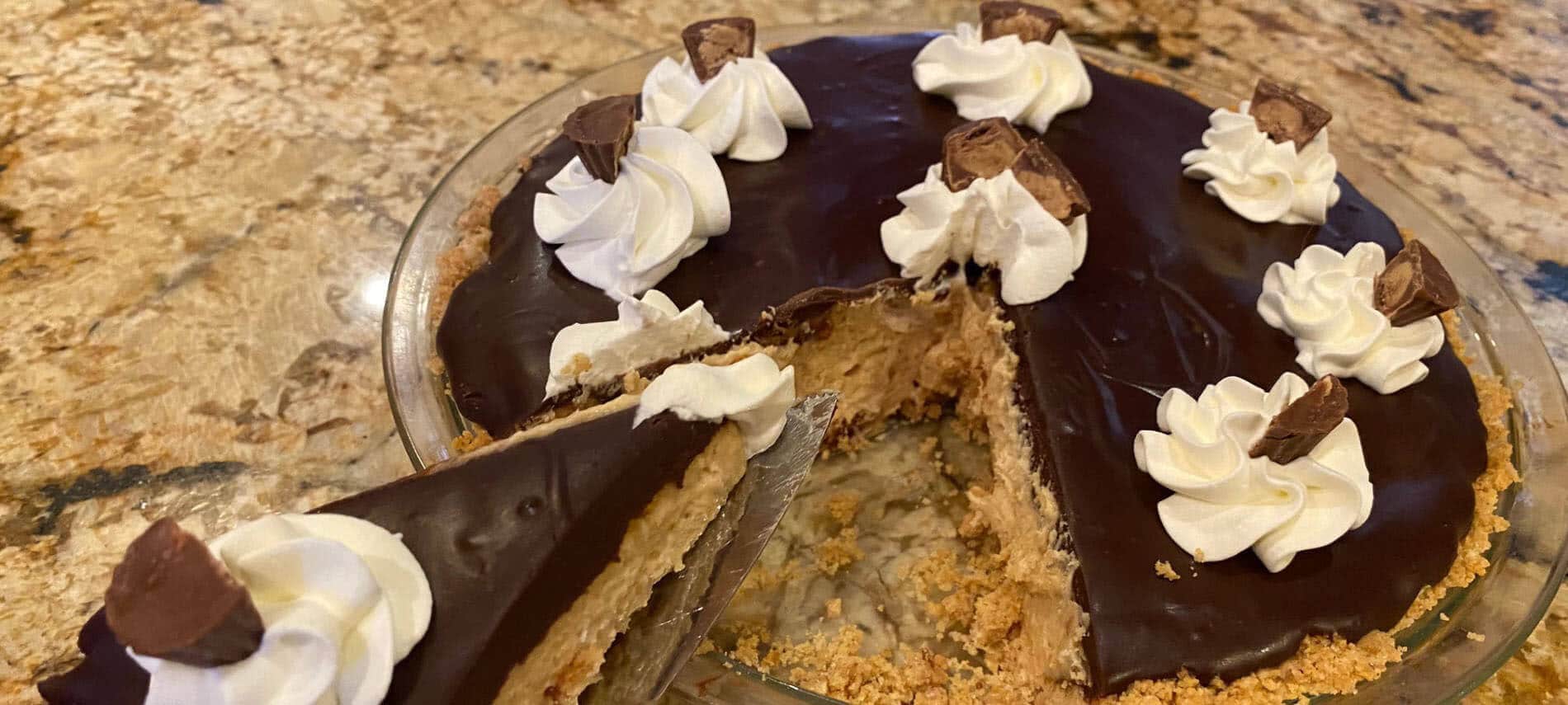 Peanut Butter Pie with dollops of whip;ped cream and peanut butter cups