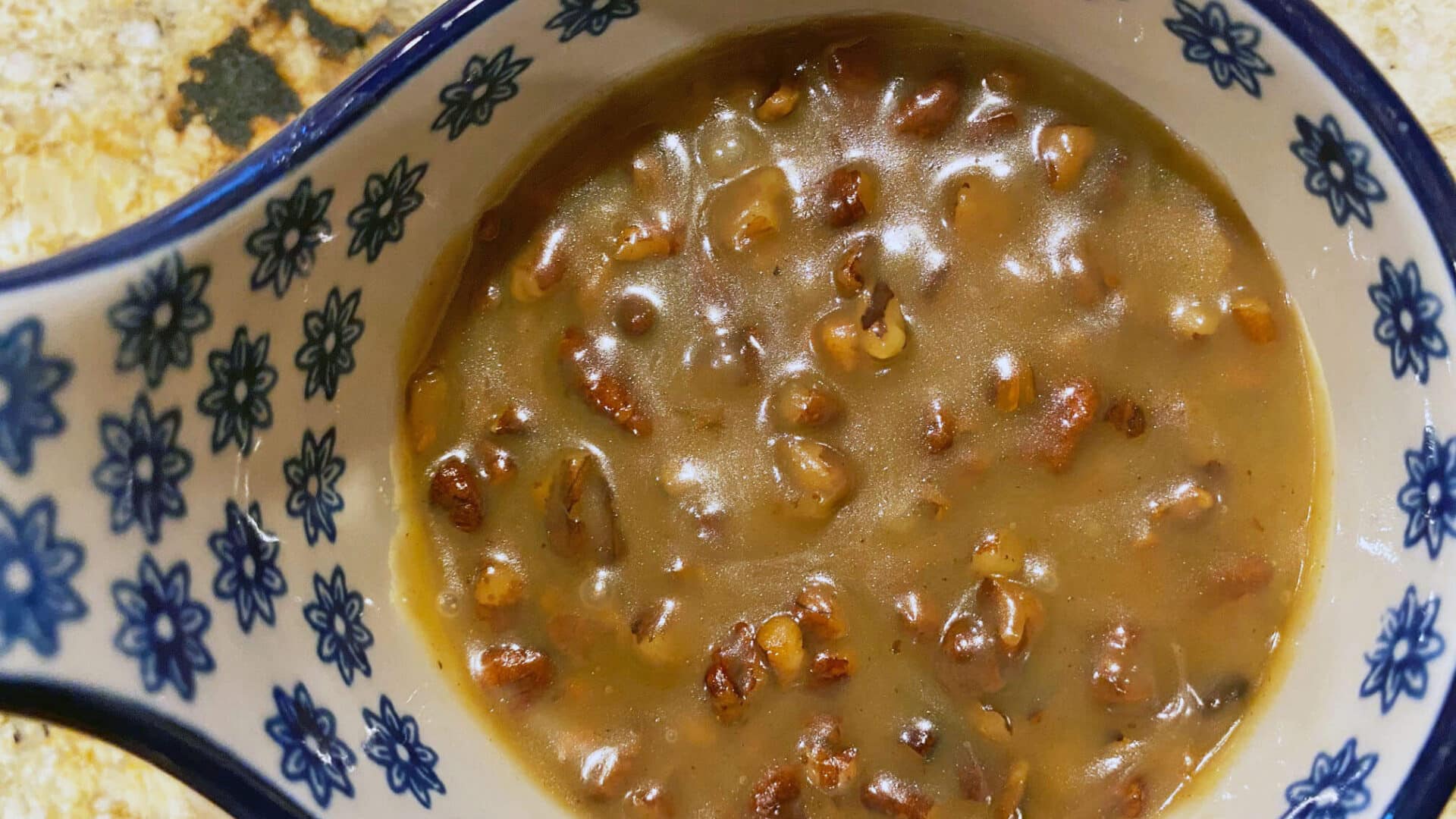 Golden brown buttery sauce with chopped pecans