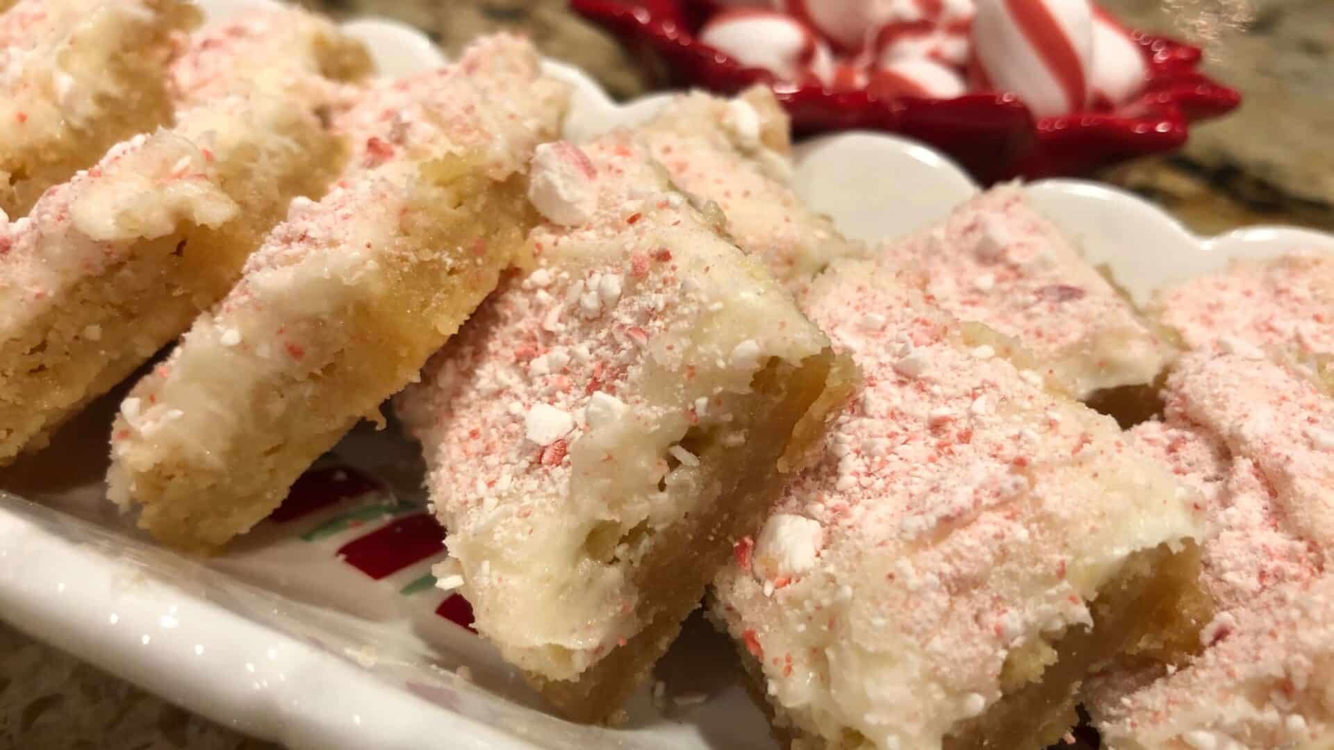 Gooey Cookie Bars with white frosting and crushed peppermint on top
