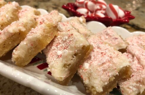 Gooey Cookie Bars with white frosting and crushed peppermint on top