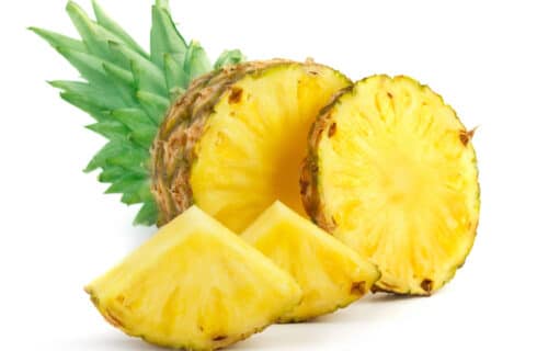 Fresh pineapple cut into slices and wedges