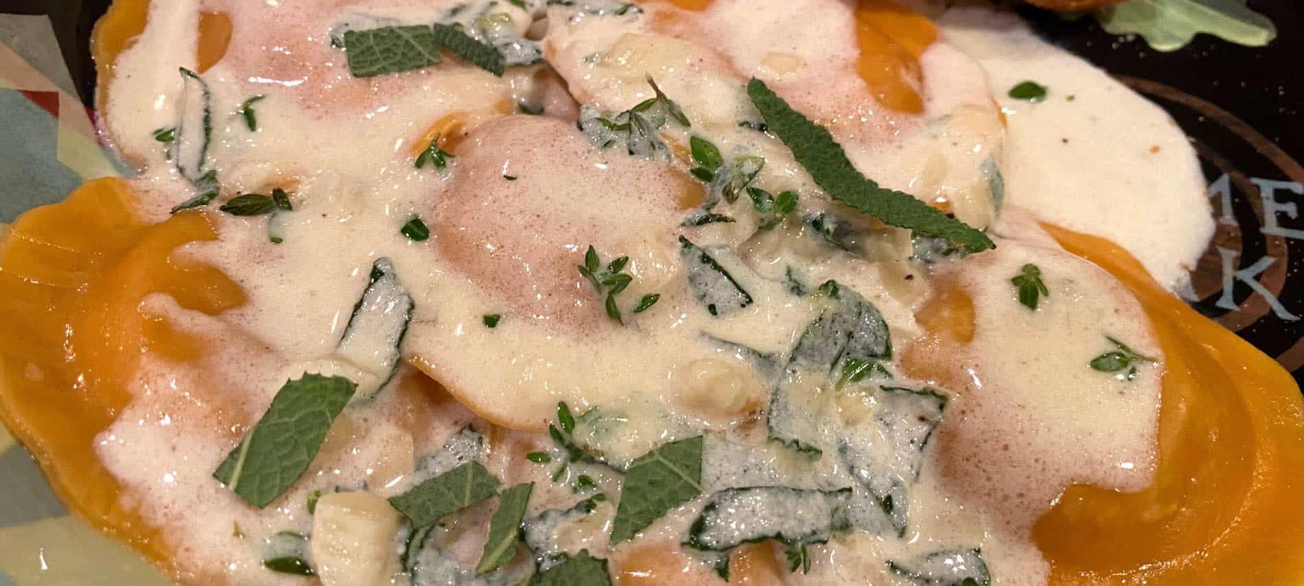 orange pumpkin ravioli with a creamy butter sage sauce