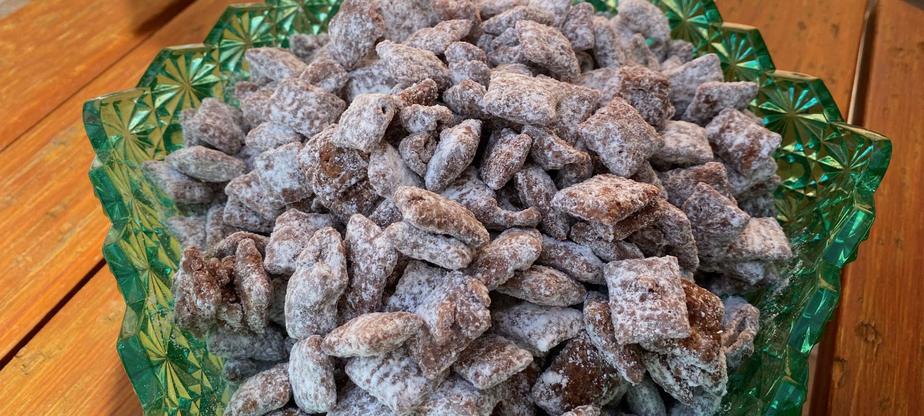 Chocolate and peanut butter coated rice cereal squares coated with powdered sugar.