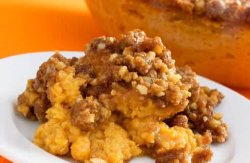 orange mashed sweet potatoes with a crispy pecan and brown sugar topping