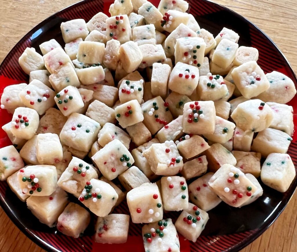 mini square shortbread cookies with white, green, and red sprinkles.