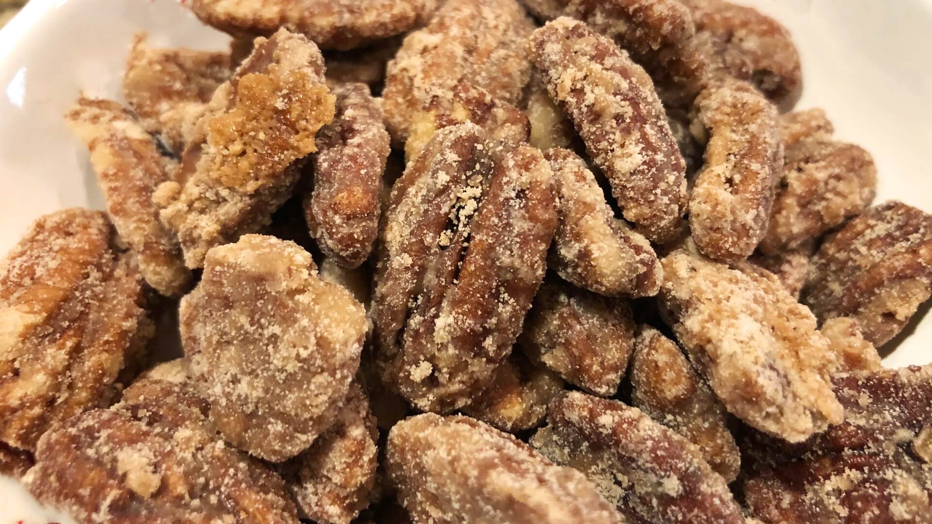 a bowl of cinnamon and sugar coated pecans
