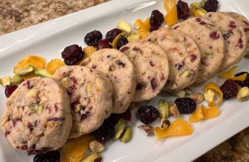 Round shortbread cookies filled with dried cranberries, pistachios and orange zest.