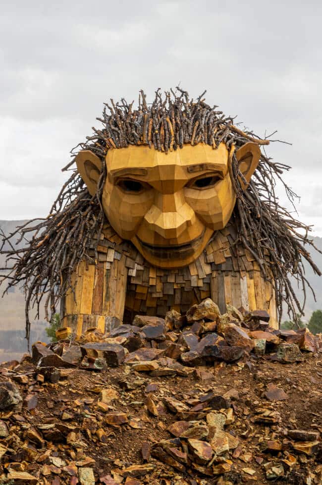 A large wood troll named Rita the Rock Planter made out of recycled wood.