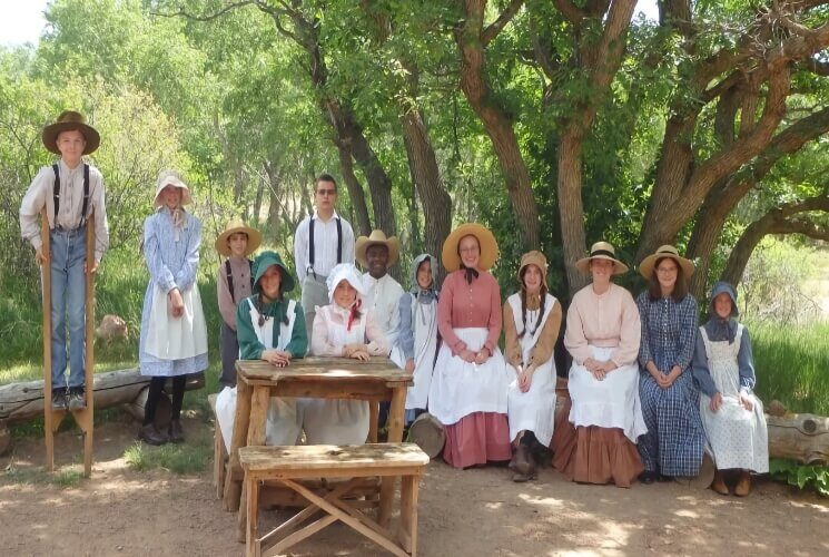 a group of people in historical 1800's pioneer costume